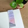 Moody Sunset bookmark with book and plant on desk