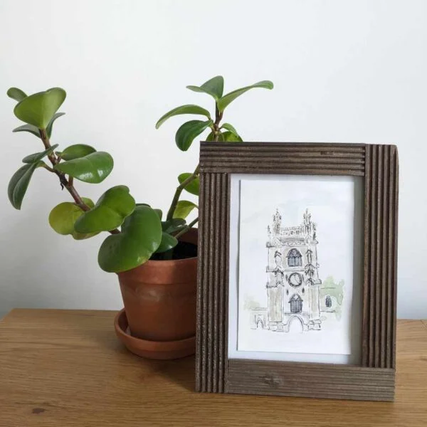 Soldiers’ Tower painting in frame with plant on desk