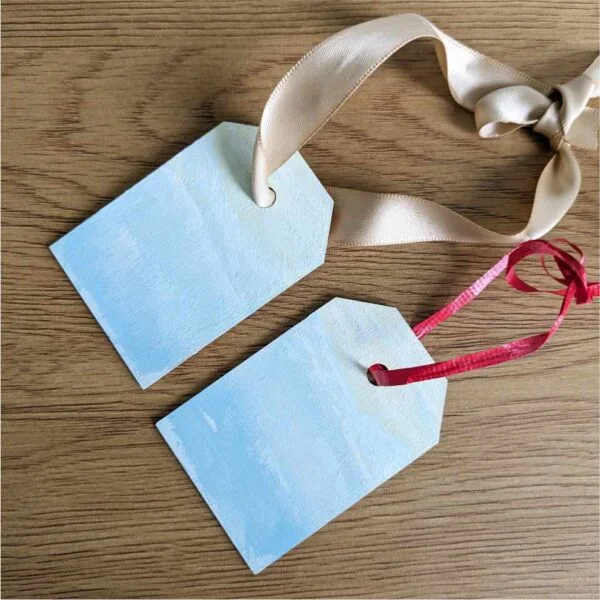 gift tags with Winter Mountains scene hanging as ornaments on table