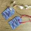 gift tags with abstract purple design as ornaments on table