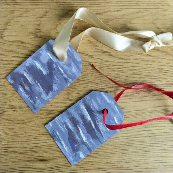 gift tags with abstract purple design as ornaments on table