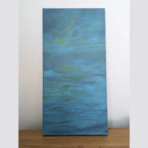 table with large canvas with abstract painting containing blue, purple and green colours