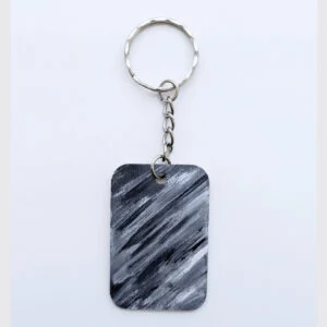 wood keychain with monochrome abstract design