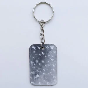 wood keychain with monochrome abstract design