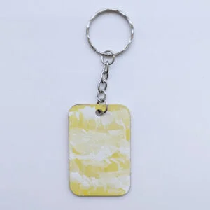 wood keychain with yellow abstract design