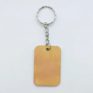 wood keychain with yellow and orange abstract design