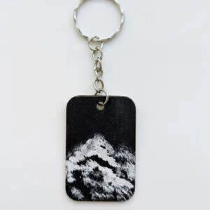 wood keychain with monochrome abstract design